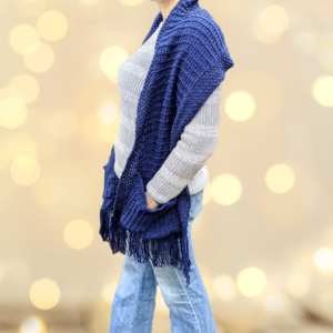 A royal blue organic merino/cotton pocket scarf is modeled by a woman woman wearing jeans and a gray sweater