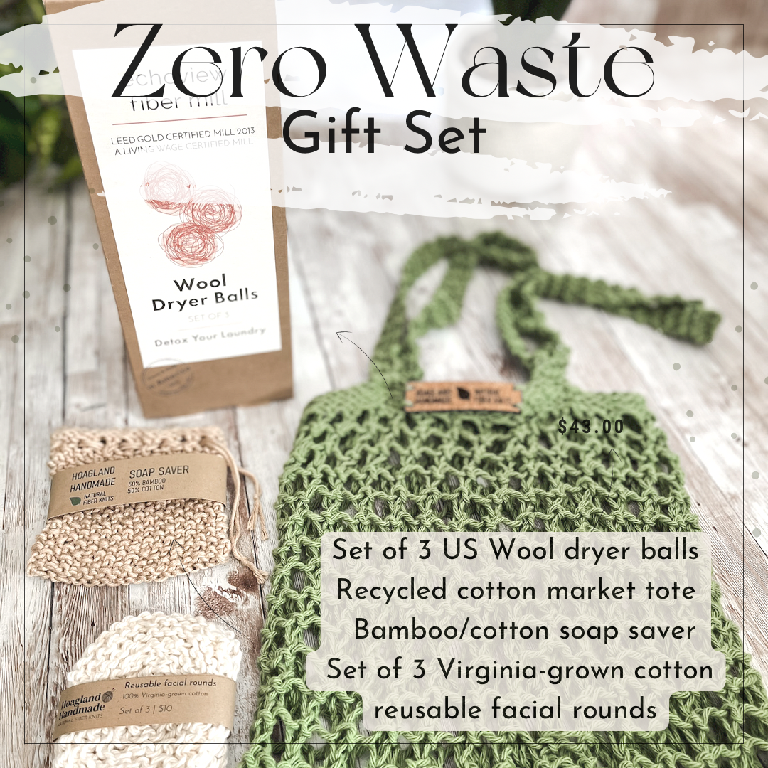 The Zero Waste gift set is pictured showing a box of 3 US Wool dryer balls, a tan bamboo/cotton soap saver pouch wrapped in a kraft paper label from Hoagland Handmade, a set of 3 usable facial rounds knit from Virginia-grown cotton and wrapped in a a kraft paper label from Hoagland Handmade, and a green recycled cotton knit market tote. The text on the image reads "Zero Waste Gift Set" and a list of the items in the photo