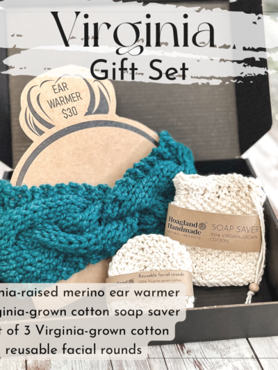 A black box contains a teal hand-dyed merino ear warmer displayed on a Kraft paper head with a messy bun, a Virginia-grown cotton soap saver and set of reusable facial rounds. The box sits on a wood panel. The text on the image reads "Virginia gift set" and includes a list of the items included in the Virginia gift set